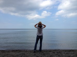 Woman looking out over the ocean towards the horizon